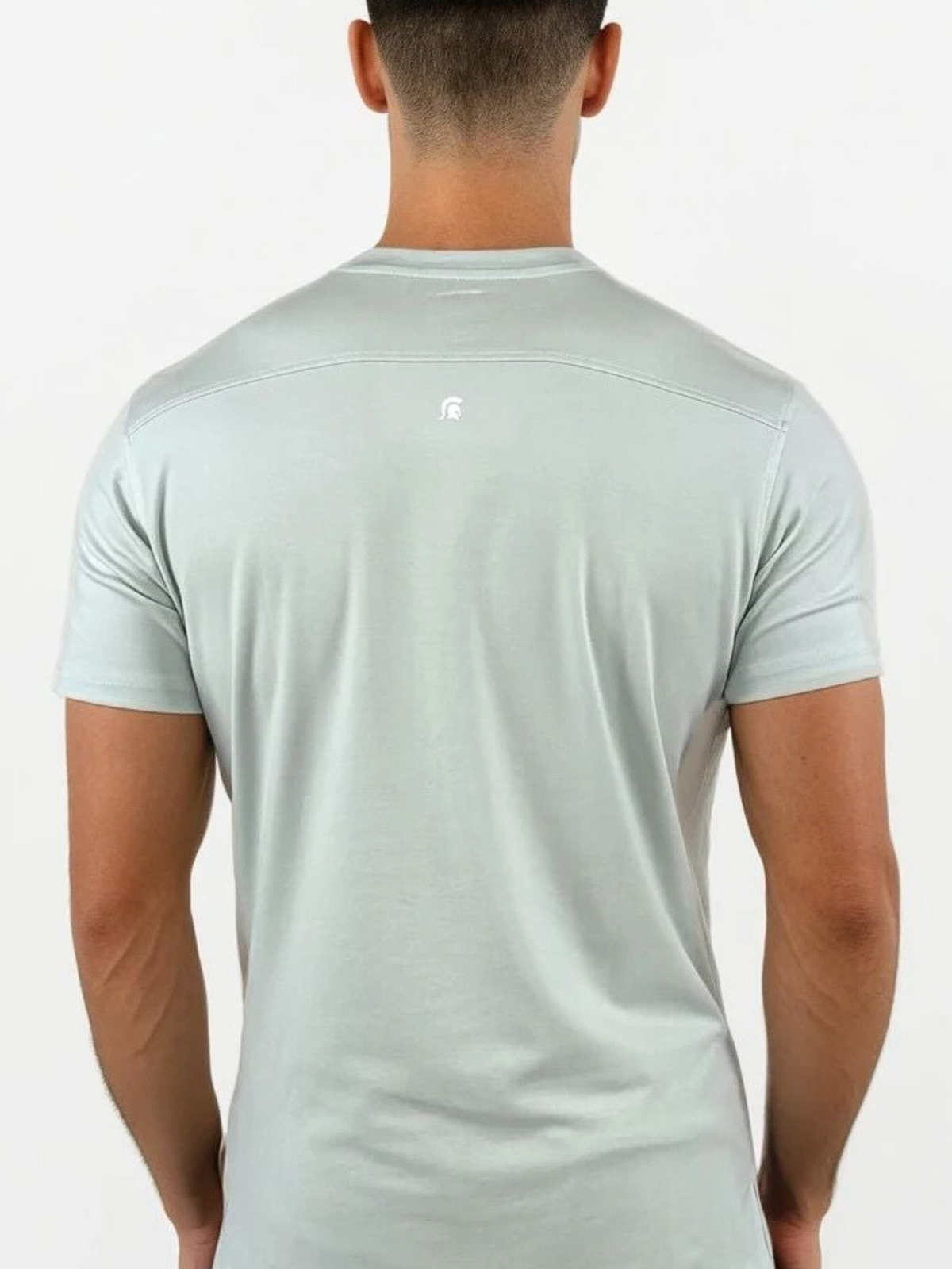 Man wearing a light gray t-shirt on a white background