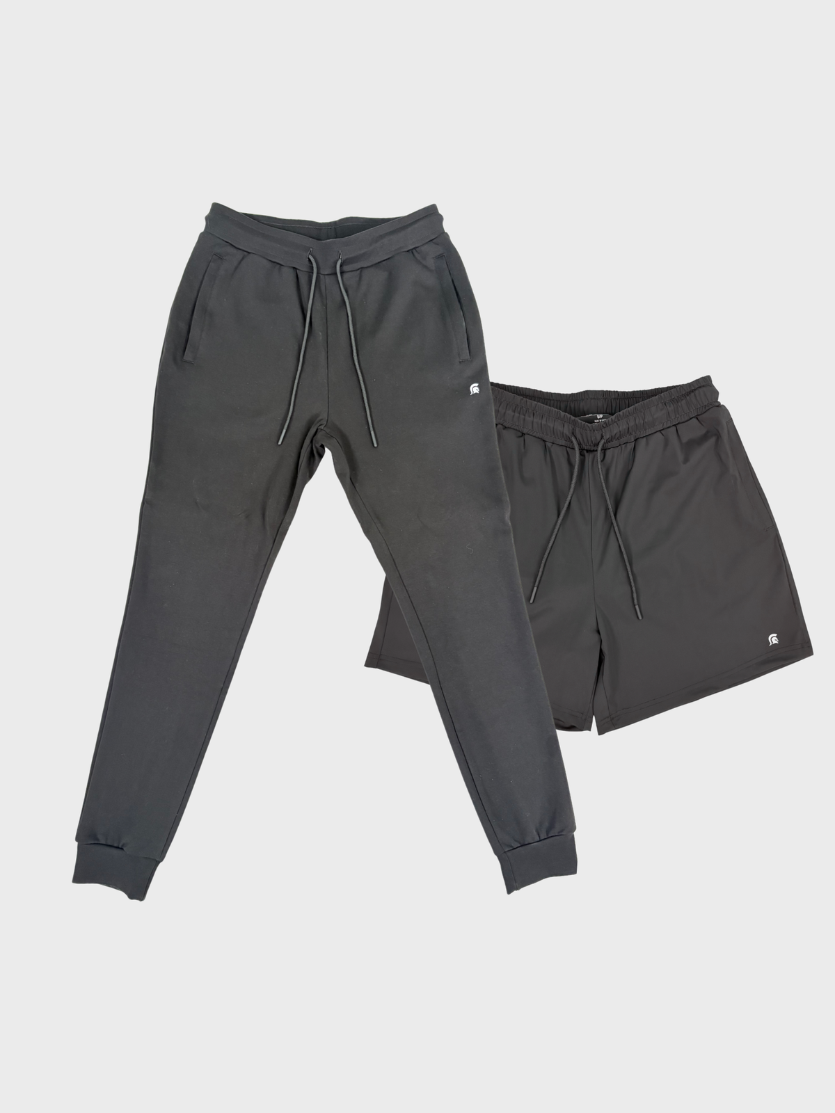 Gray sweatpants and shorts set on a light gray background